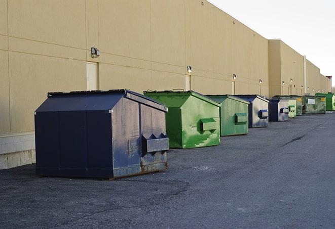 a collection of bright and vibrant dumpsters in a construction zone in Cambridge MA